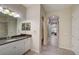 Bathroom featuring a granite countertop vanity and access to hall at 6001 Anise Dr, Sarasota, FL 34238