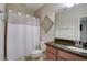 Bright bathroom features a shower with white curtain and a granite-topped vanity with a sink at 6001 Anise Dr, Sarasota, FL 34238