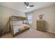 Comfortable bedroom featuring a bunk bed, ceiling fan, and a colorful art piece at 6001 Anise Dr, Sarasota, FL 34238