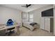 Bright bedroom featuring a ceiling fan, a flat-screen tv, a bed and a desk at 6001 Anise Dr, Sarasota, FL 34238