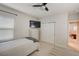 Cozy bedroom with mounted TV, light walls, closet, and dresser at 6001 Anise Dr, Sarasota, FL 34238