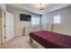 Cozy bedroom featuring three dressers, light walls, and a mounted TV at 6001 Anise Dr, Sarasota, FL 34238