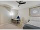Well-lit bedroom complete with a ceiling fan, desk, chair, bedside table, and decorated furnishings at 6001 Anise Dr, Sarasota, FL 34238