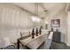 Elegant dining room featuring wainscoting, a modern chandelier, and stylish upholstered chairs at 6001 Anise Dr, Sarasota, FL 34238