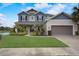 Charming two-story home with a well-manicured lawn and lush landscaping at 6001 Anise Dr, Sarasota, FL 34238