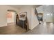 Inviting foyer with wood-look tile flooring, decorative console table, and staircase to the upper level at 6001 Anise Dr, Sarasota, FL 34238
