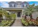 Close-up of the front door and attractive landscaping leading to the entryway at 6001 Anise Dr, Sarasota, FL 34238