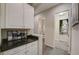 Hallway to half bath with storage and access to the HVAC closet at 6001 Anise Dr, Sarasota, FL 34238