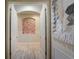 Hallway with interior brick accent and plank flooring at 6001 Anise Dr, Sarasota, FL 34238