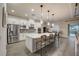 Modern kitchen with a large center island, stainless steel appliances, and a view of the outdoor pool at 6001 Anise Dr, Sarasota, FL 34238