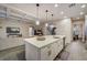 Bright, open kitchen with large island, modern lighting, and seamless transition to living area at 6001 Anise Dr, Sarasota, FL 34238