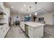 Bright, open kitchen features a large center island, modern appliances, and a seamless flow into the living area at 6001 Anise Dr, Sarasota, FL 34238