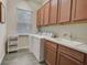 Functional laundry room with cabinets, sink, and modern washer and dryer at 6001 Anise Dr, Sarasota, FL 34238