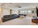 Spacious living room featuring a pool table, comfortable seating, and natural light at 6001 Anise Dr, Sarasota, FL 34238