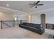 Large living room features a black couch, ceiling fan, and coffered ceiling detail at 6001 Anise Dr, Sarasota, FL 34238