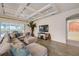 Comfortable living room boasts a coffered ceiling, backyard views, and a stylish sectional sofa at 6001 Anise Dr, Sarasota, FL 34238