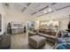 Open-concept living area flowing into kitchen, featuring coffered ceiling and wood-look flooring throughout at 6001 Anise Dr, Sarasota, FL 34238