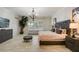Bedroom with wood-look tile floor, indoor tree, comfortable seating, and dark furniture at 6001 Anise Dr, Sarasota, FL 34238