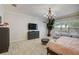 Bedroom with indoor tree, elegant light fixture, and comfortable seating at 6001 Anise Dr, Sarasota, FL 34238