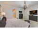 Bedroom features a wood chandelier and wood-look tile floors at 6001 Anise Dr, Sarasota, FL 34238