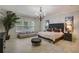 Bedroom with an elegant light fixture, indoor tree, and comfortable seating at 6001 Anise Dr, Sarasota, FL 34238