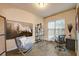 Cozy home office with a horse-themed art piece, a glass desk, and natural light from the window at 6001 Anise Dr, Sarasota, FL 34238