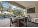 Outdoor kitchen with dining area, stainless steel grill, and view of the pool at 6001 Anise Dr, Sarasota, FL 34238