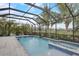 Spacious screened-in pool and spa surrounded by lush landscaping at 6001 Anise Dr, Sarasota, FL 34238