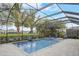 Screened-in pool with spa, lounge chairs, and lush tropical landscaping at 6001 Anise Dr, Sarasota, FL 34238