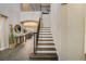 Elegant staircase with dark wood railing, leading to the upper level of the home at 6001 Anise Dr, Sarasota, FL 34238