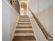 Staircase with wood treads, white risers, and a decorative railing at 6001 Anise Dr, Sarasota, FL 34238
