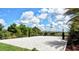 Community sand volleyball court surrounded by mature landscaping and trees at 6001 Anise Dr, Sarasota, FL 34238