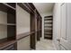 Spacious walk-in closet with custom dark wood shelving and drawers at 6001 Anise Dr, Sarasota, FL 34238