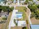 Aerial view of a home, showing a large yard with a circular driveway, and a gravel parking area for boats and RVs at 612 Shore Rd, Nokomis, FL 34275