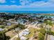 An aerial view showcasing the community near the ocean, interspersed with a charming canal system, with scattered homes and tropical trees at 612 Shore Rd, Nokomis, FL 34275