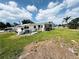 Fenced backyard with ample space for outdoor activities and a small utility shed at 612 Shore Rd, Nokomis, FL 34275