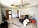 Spacious bedroom with ceiling fan, vinyl floors, and damaged ceiling at 612 Shore Rd, Nokomis, FL 34275