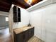 Close-up of dark cabinets with wood countertop, built-in shelves, and neutral walls at 612 Shore Rd, Nokomis, FL 34275