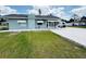 Quaint single-story home featuring awnings, an inviting porch, and a well-maintained lawn at 612 Shore Rd, Nokomis, FL 34275