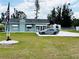 Charming single-story home with a well-maintained lawn, white gravel driveway, and the US flag waving proudly at 612 Shore Rd, Nokomis, FL 34275