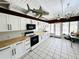 Spacious kitchen with white cabinets, black hardware, and stainless steel sink at 612 Shore Rd, Nokomis, FL 34275