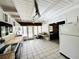 Kitchen area showcasing white cabinets, wood countertops, and open access to adjacent rooms at 612 Shore Rd, Nokomis, FL 34275
