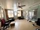 Bright sunroom features many windows offering natural light, with a ceiling fan for added comfort at 612 Shore Rd, Nokomis, FL 34275
