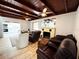 Open living room featuring fireplace, cozy seating, and wood ceiling at 612 Shore Rd, Nokomis, FL 34275