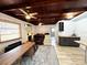 Cozy living room with wood ceiling, decorative fireplace, and comfortable seating at 612 Shore Rd, Nokomis, FL 34275
