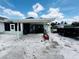 View of the home's rear patio, covered by an awning and plenty of outdoor space at 612 Shore Rd, Nokomis, FL 34275