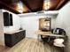 Room featuring dark cabinets, wood countertop, desk, and laminate flooring at 612 Shore Rd, Nokomis, FL 34275