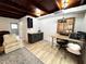 Room featuring dark cabinets, wood countertop, desk, and an open design to living area at 612 Shore Rd, Nokomis, FL 34275