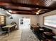 Open room showing wood ceiling, desk and kitchen area with view of updated cabinets at 612 Shore Rd, Nokomis, FL 34275