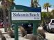 A Nokomis Beach Park sign invites visitors to enjoy the natural beauty of the park at 612 Shore Rd, Nokomis, FL 34275